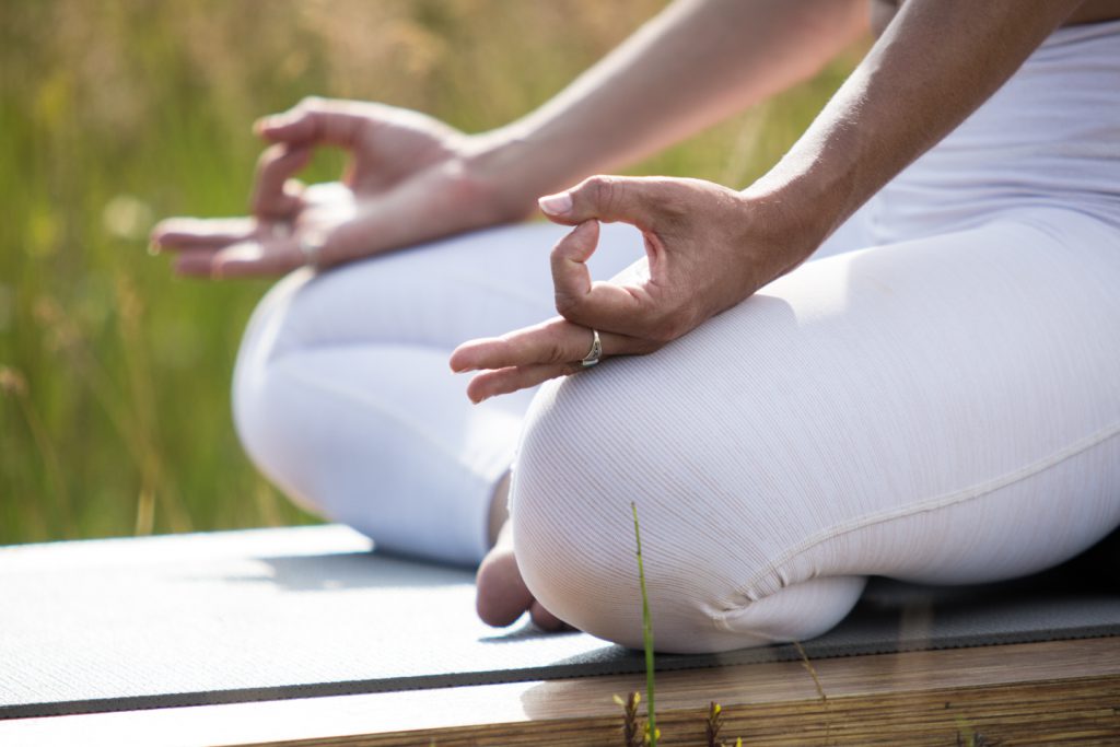 woman seated practicing meditation 