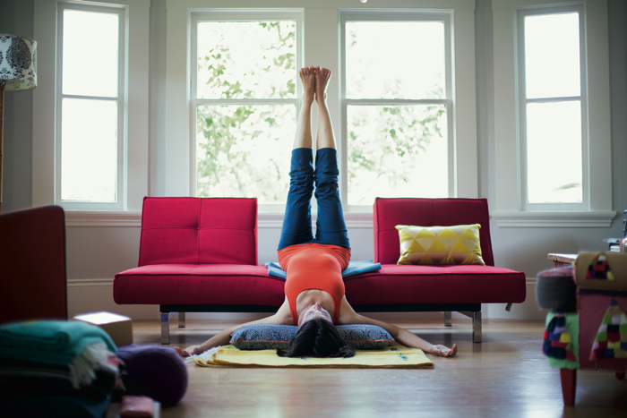 woman practices yoga at home -yogatoday