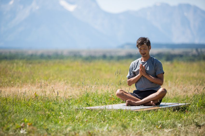 Man Practices Mindfullness Outdoors in Grand Teton National Park -YogaToday