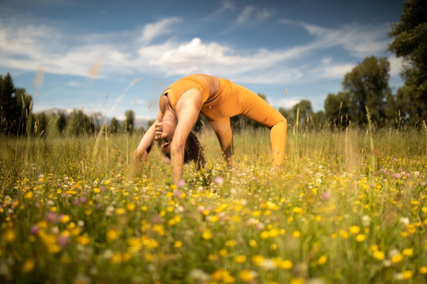 woman practices yoga outdoors