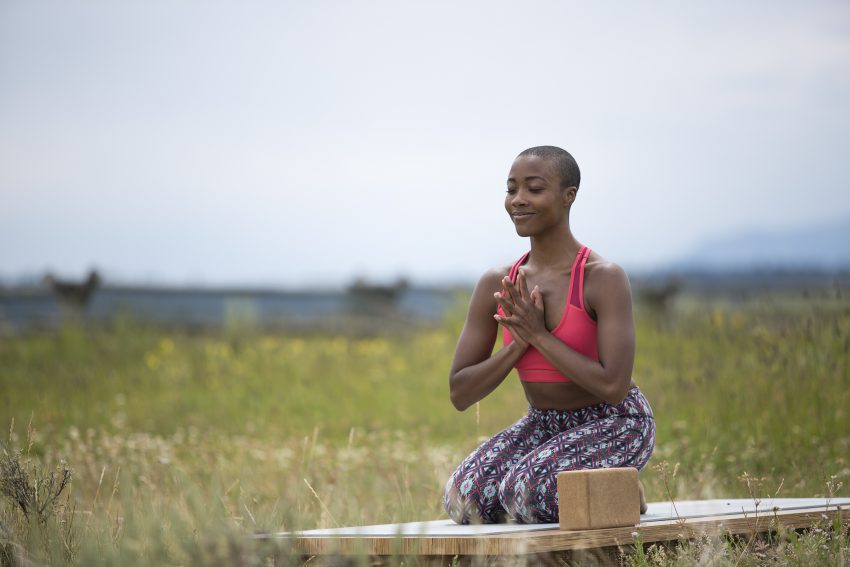 Woman Meditates Outdoors in Grand Teton National Park